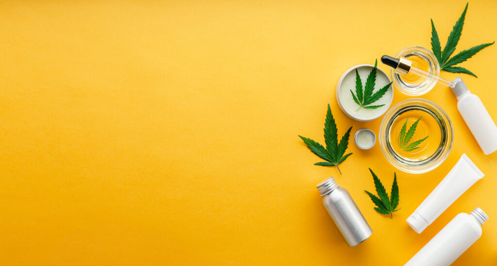 Top Marijuana Products For Beauty. Yellow background with marijuana leaves and bottles.