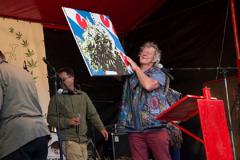 Popular illegal cannabis farmer in Holland holding a painting.