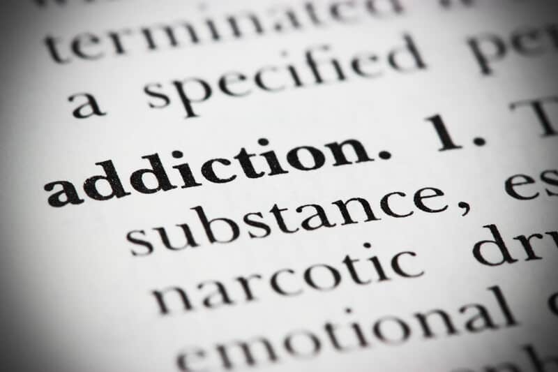 addiction in bold on a page with words, top signs of cannabis addiction