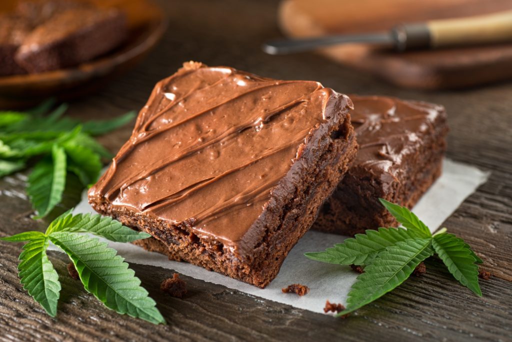 Adding cannabis to your favorite recipes. Brownies and marijuana leaves