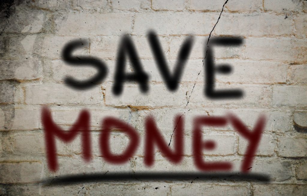 Smoke weed and save money. "Save money" spray painted on a brick wall.