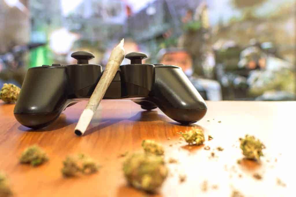 Video games and cannabis. Video game controller, big joint and g