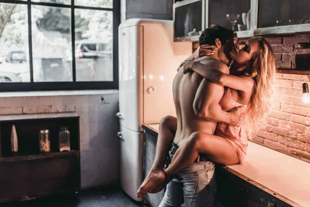 Couple having sex in kitchen. 
