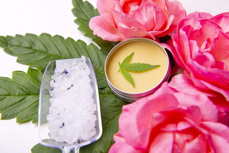 cbd salve with weed leaf next to ice and roses, could cbd salve help with joint pain