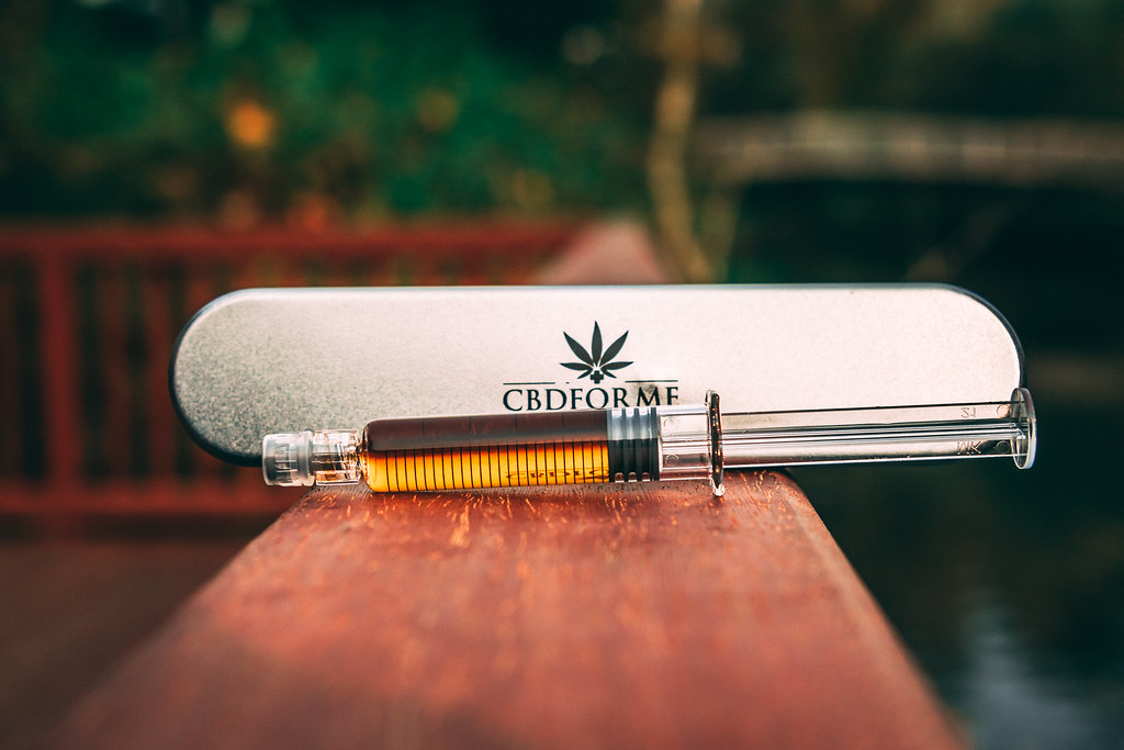 CBD oil applicator in a metal tin