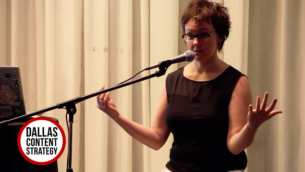 Woman speaking into a microphone at a Dallas Content Strategy event