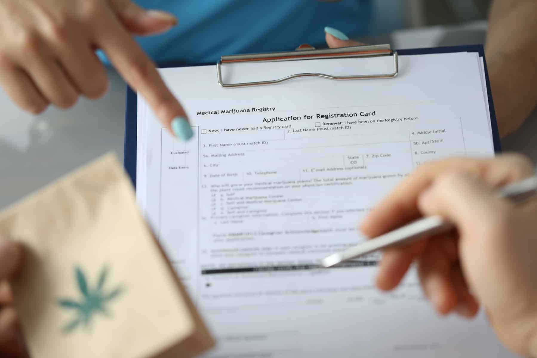 Patient filling application for registration card, medical marijuana evaluation