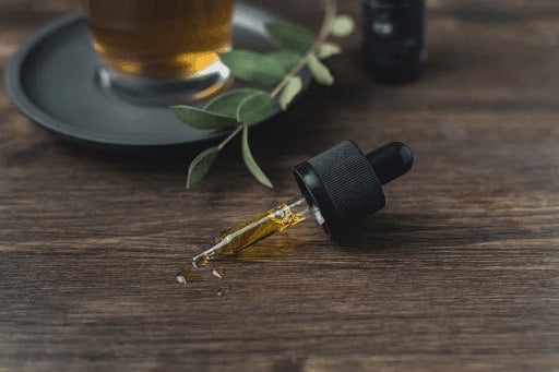 CBD oil topper on wood table, products CBD is added to