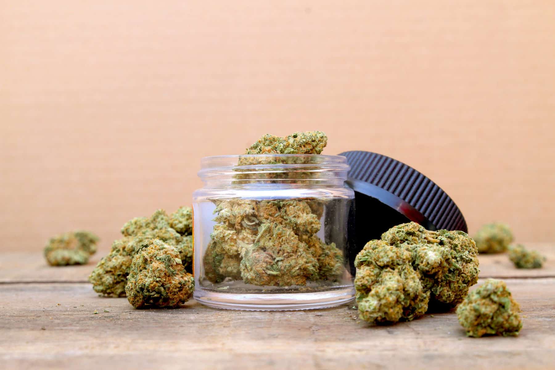Marijuana in Open Jar Surrounded by Buds - Centered, cannabis pros and cons