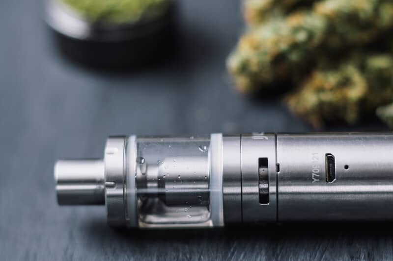 vape next to cannabis buds, transition from smoking to vaping